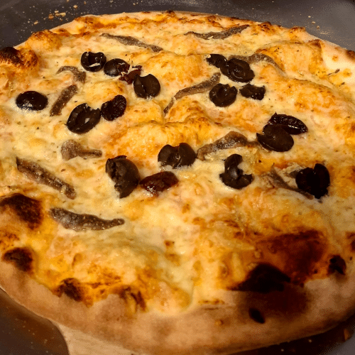 Pizza mit Sardellen, Oliven und Knoblauch